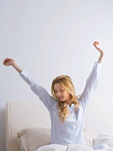 Ease pain easily woman waking up in bed